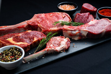 raw tomahawk with rosemary and salt on a wooden board