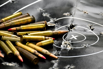 Pile of bullets or ammunitions on black man-target shooting, soft and selective focus.