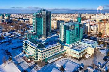 Fototapeta na wymiar Surgut city in winter. Gazprom Transgaz Surgut and Gazprombank buildings. Aerial view.