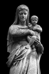 Fototapeta na wymiar Virgin Mary with the baby Jesus Christ. An ancient statue isolated on black background.