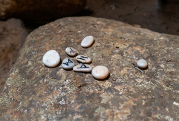 Small  pebbles with pagan runes lie on a large stone in remnants of the megalithic complex of the early Bronze Age  - Wheels of Spirits - Rujum Al-Hiri - Gilgal Rephaeem - on Golan Heights in Israel