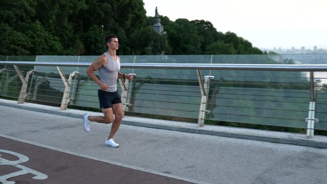 muscular young man runner in sportswear running and training stamina, jog