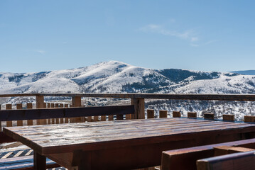 Wooden table in mountain restaurant with beautiful view