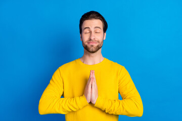 Portrait of attractive dreamy calm brunet guy meditating isolated over bright blue color background