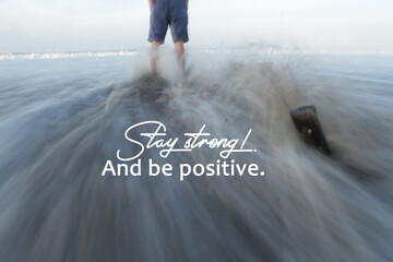 Inspirational and motivational quote - Stay strong! And be positive. With person standing alone on...