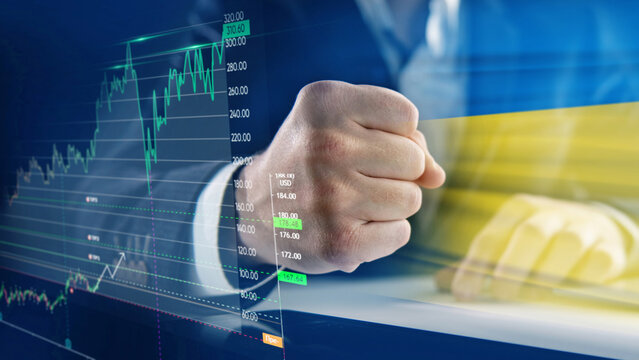 the businessman clenched his hand against the background of the Ukrainian flag into a fist. The concept of assistance and economic growth with the help of the countries of the European Union
