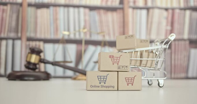 Consumer rights and protection, business law concept : Shopping cart, wooden judge gavel, a balanced scale of justice on a table, depicting the practice of safeguarding buyers of goods and services.