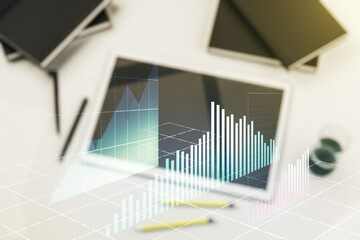 Double exposure of abstract creative financial chart and digital tablet on background, top view, research and strategy concept