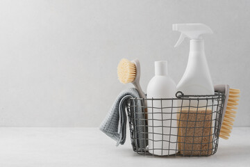 Set of detergents In basket. Cleaning agent, rag, sponge, brushes. Cleaning service concept