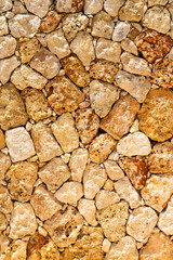 Brown rough sea stones on the coast, abstract background