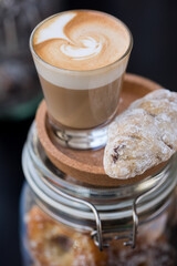 cup of coffee served with a biscuit 