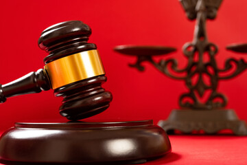 gavel on red with a scale on background
