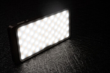 mini portable photography LED light on a dark background