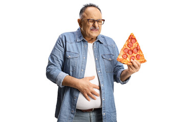 Mature man holding a slice of pepperoni pizza and holding his belly in pain