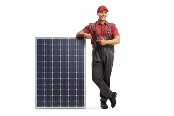 Full length portrait of a worker leaning on a solar panel and pointing