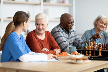Nurse having conversation with attractive senior woman