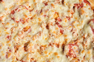 Pizza background - macro shot of pizza with cheese and sausage