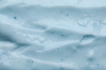 Closeup view of light blue body cream as background