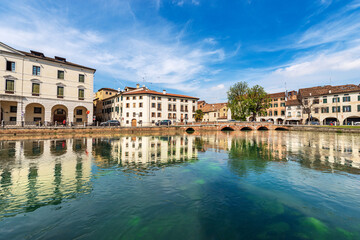 Fototapeta na wymiar Cityscape of Treviso downtown with the river Sile with the street called Riviera Garibaldi and the small bridge called Ponte Garibaldi. Veneto, Italy, Europe.