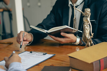 Lawyers' offices work on papers and tiger skins with hammers and scales of the Goddess of Justice on the legal advisory table.