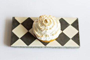 cakes on a black and white stand on a white background