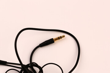 Headphone jack. Black wires. Close-up. Isolated on a white background.