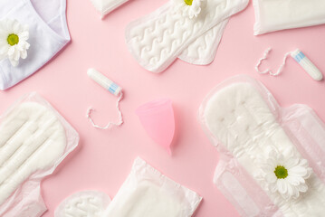 Obraz na płótnie Canvas Top view photo of hygienic pads panties camomile buds menstrual cup and tampons on isolated pastel pink background
