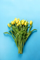 A bouquet of yellow tulips on a blue background