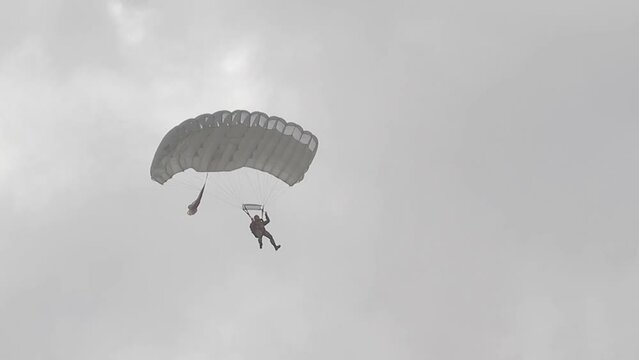 A skydiver is planning in a cloudy sky.