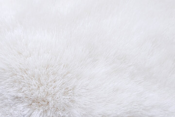 Light, white, fluffy texture of the fur background. Empty space for text, top view, selective focus, close-up. High quality photo