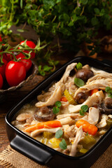 Chicken casserole. Served in black pots.