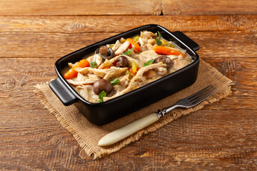 Chicken casserole. Served in black pots.