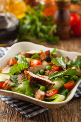 Delicious salad with grilled veal, beetroot and cucumber. Front view.