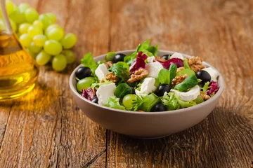 Fotobehang Italian spring salad with goat cheese, grapes and walnuts. Served with croutons. © gkrphoto
