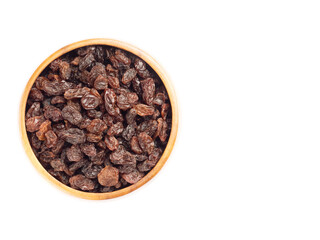 Raisin in brown wooden bowl with copy space