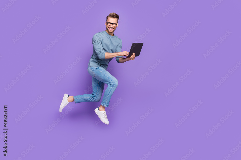 Sticker Photo of pretty handsome guy dressed grey shirt glasses jumping high chatting modern gadget isolated purple color background