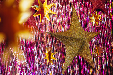 Star decoration covered with glitter hanging on foil background