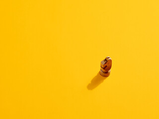 Fototapeta premium Knight or horse chess piece on yellow background