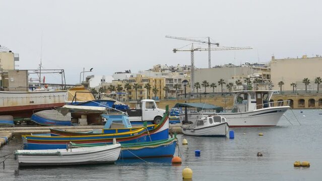 brightly painted boats and a boatyard in Marsaskala, Malta