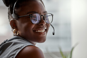 Forget call backs, lets get it fixed now. Shot of a young woman using a headset in a modern office.