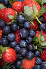 Full frame shot of fresh strawberries with blueberries, copy space