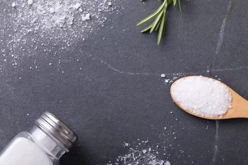 Foto op Plexiglas Directly above shot of salt with salt shaker, spoon and rosemary on table © wavebreak3
