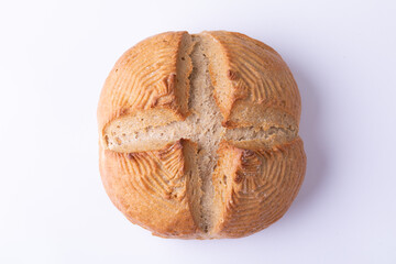 Overhead close-up of cross bun on white background