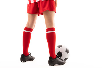 Low section of caucasian young female player standing by soccer ball against white background - Powered by Adobe