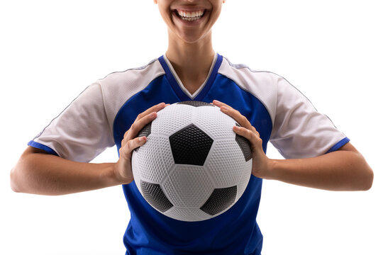 Midsection of smiling biracial young female player with soccer ball against white background