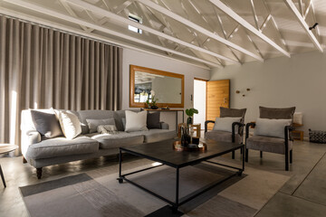 Sofa and armchairs by center table in living room at home