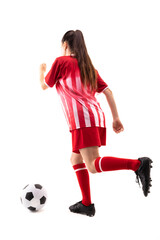 Full length of caucasian young female soccer player playing soccer against white background