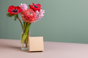 Cardboard box mockup and flower arrangement in vibrant colors. Spring template for Mother's day, Women's day, wedding, birthday. Copy space.