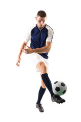 Confident young male caucasian player kicking ball against white background
