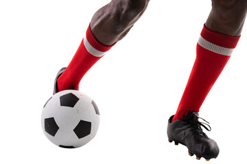 Low section of young male african american athlete kicking soccer ball against white background